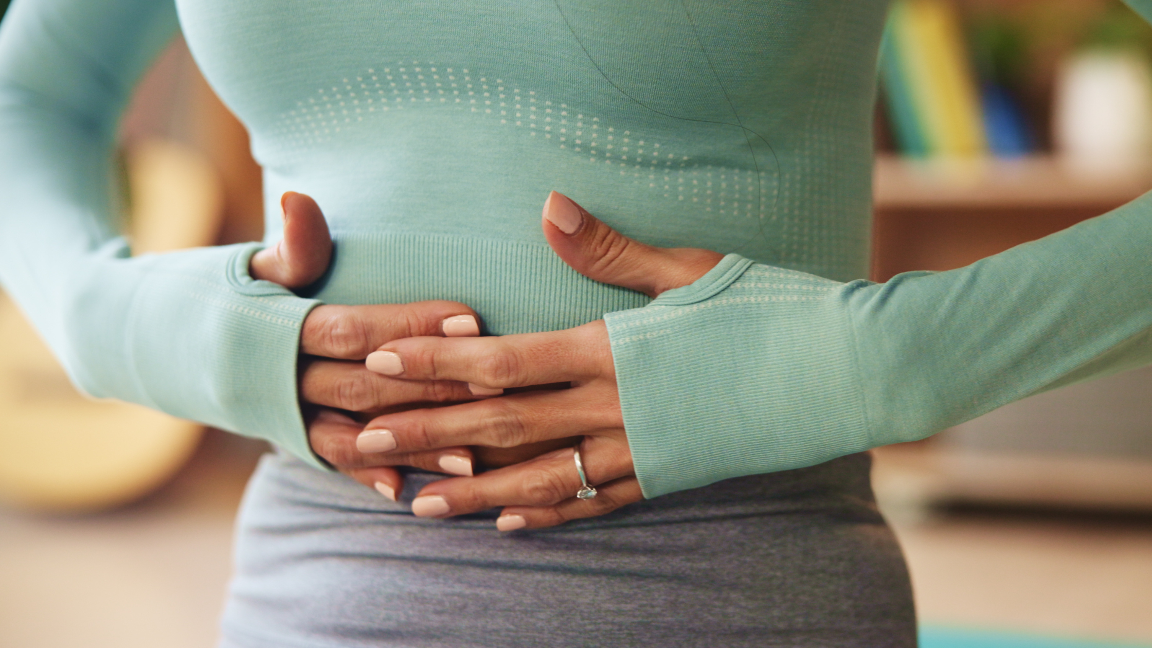 woman holding her stomach in pain