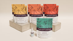 Renew Core set on a plaster block: Radiant Morning and Reviving Daily Kitchari pouches, Clarifying Herbal Tea and a Lightening Hydration Drops bottle.